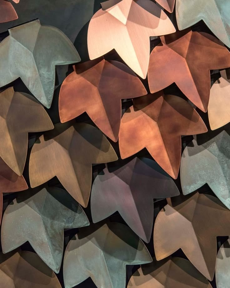 Vertical metal disc screen facade filtering daylight across a glazed elevation