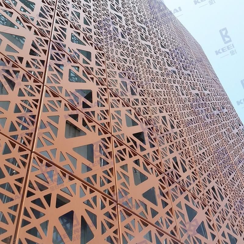 Curved perforated copper-toned ACP screen wrapping a commercial tower